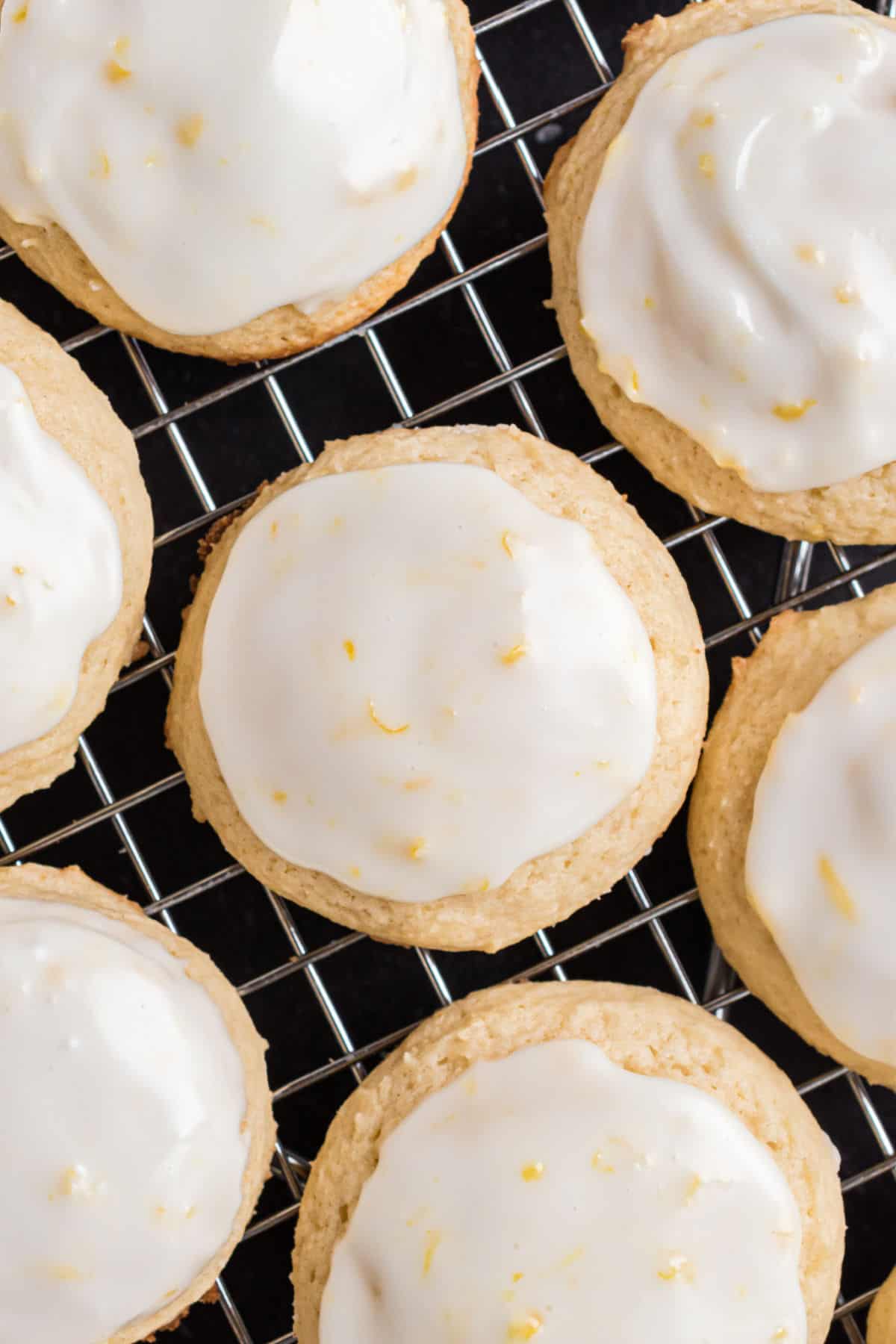 Lemon iced ricotta cookies on wire rack.