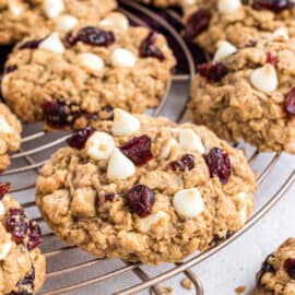 White chocolate cranberry oatmeal cookies on a cooling rack.