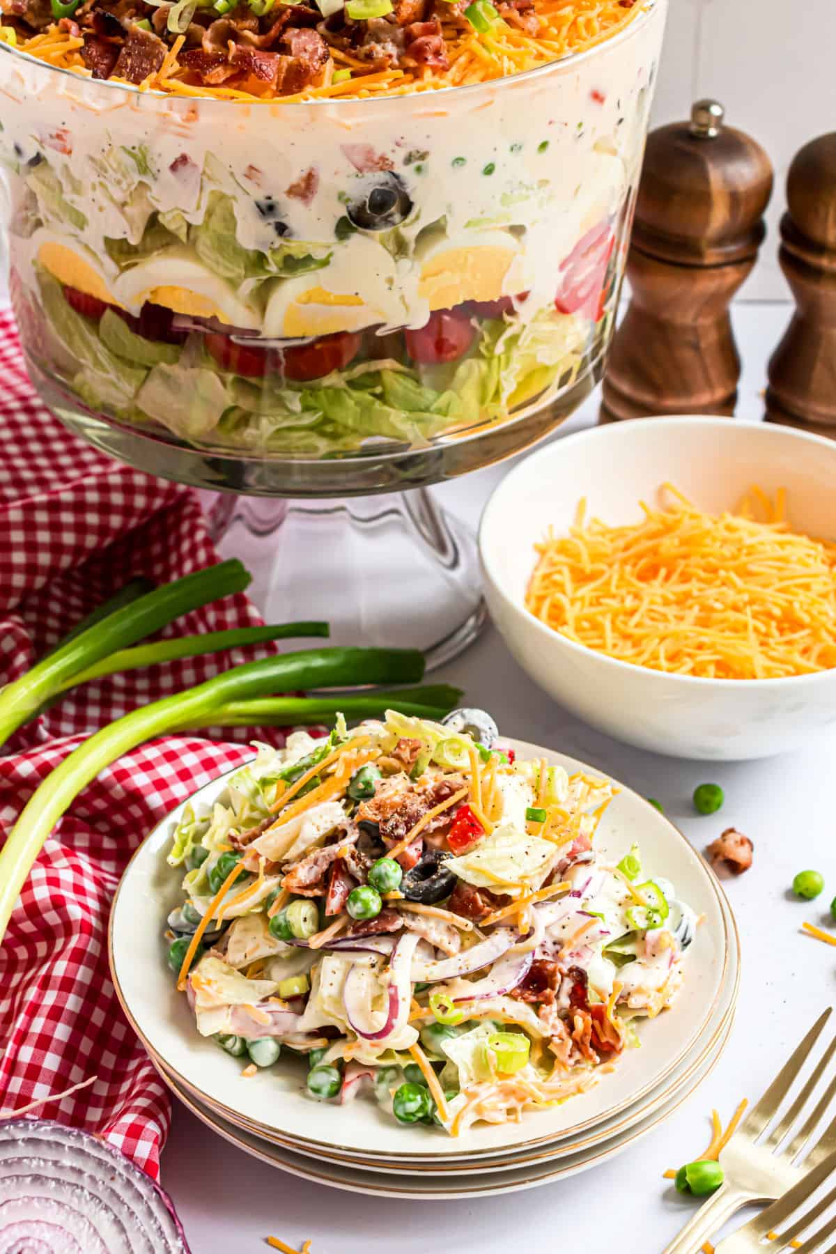 Seven layer salad served on a white plate.