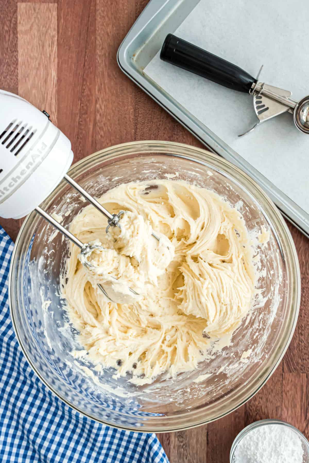 Cheesecake cookie dough in a clear glass mixing bowl.