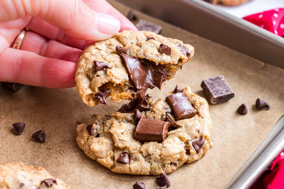 Gooey chocolate chips in a broken chocolate chunk cookie.
