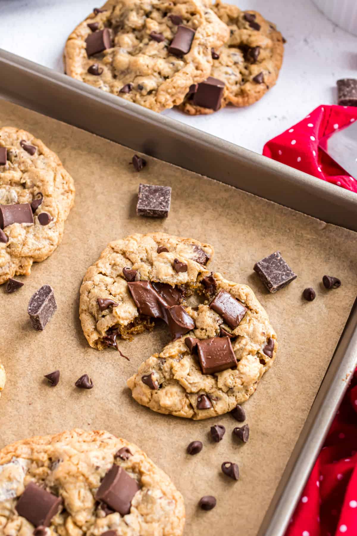 Oatmeal chocolate chunk cookie on a parchment paper lined cookie sheet.