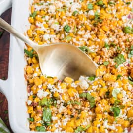Mexican street corn salad baked in square dish.