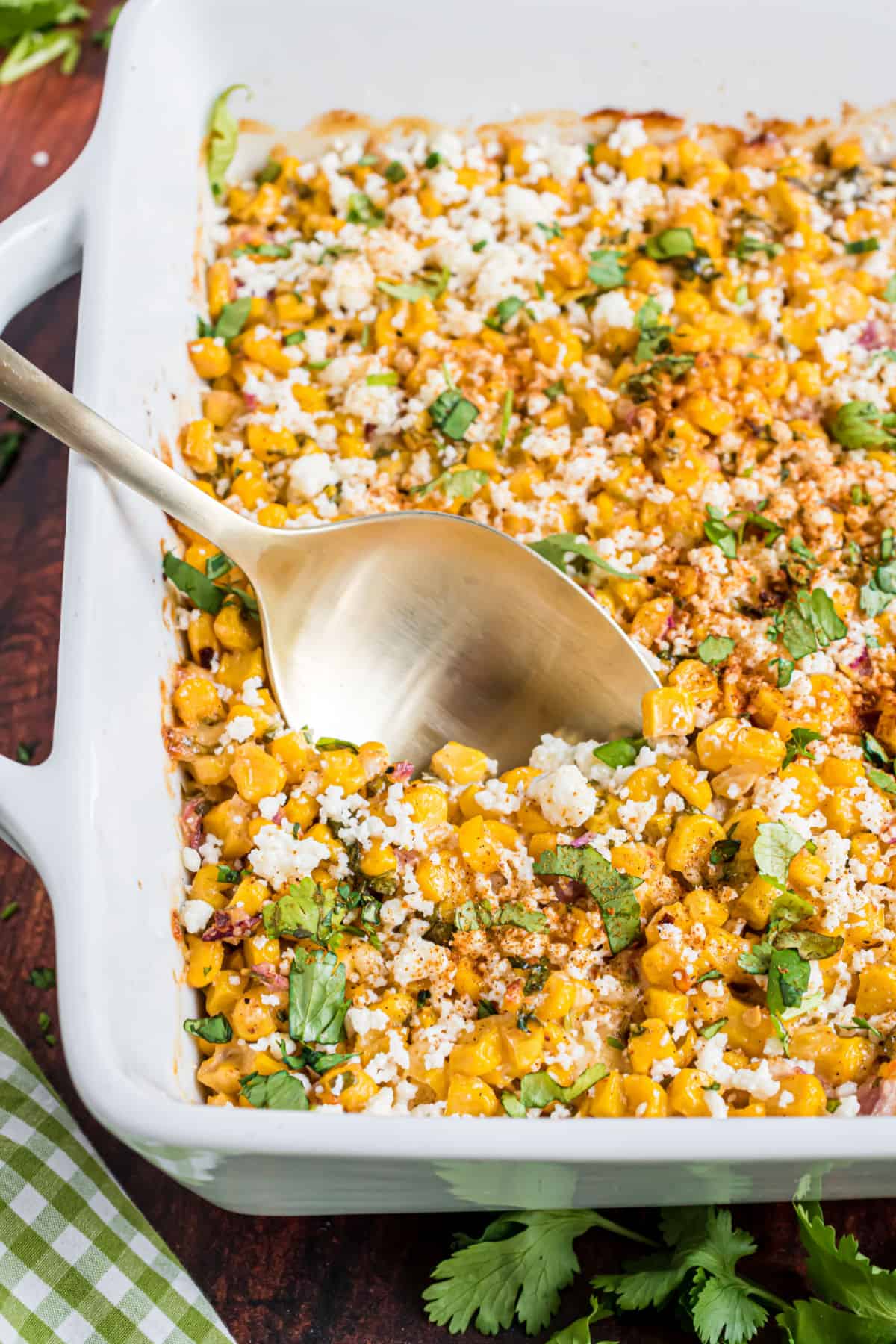 Mexican street corn salad baked in square dish.