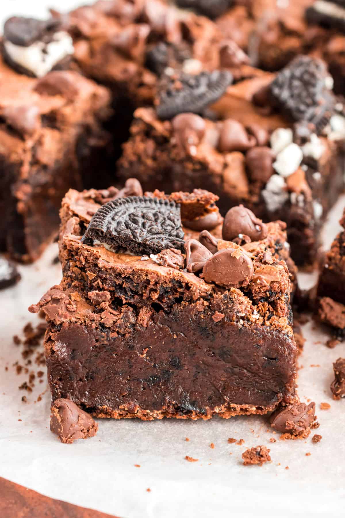 Oreo brownies on parchment paper and cut into squares.