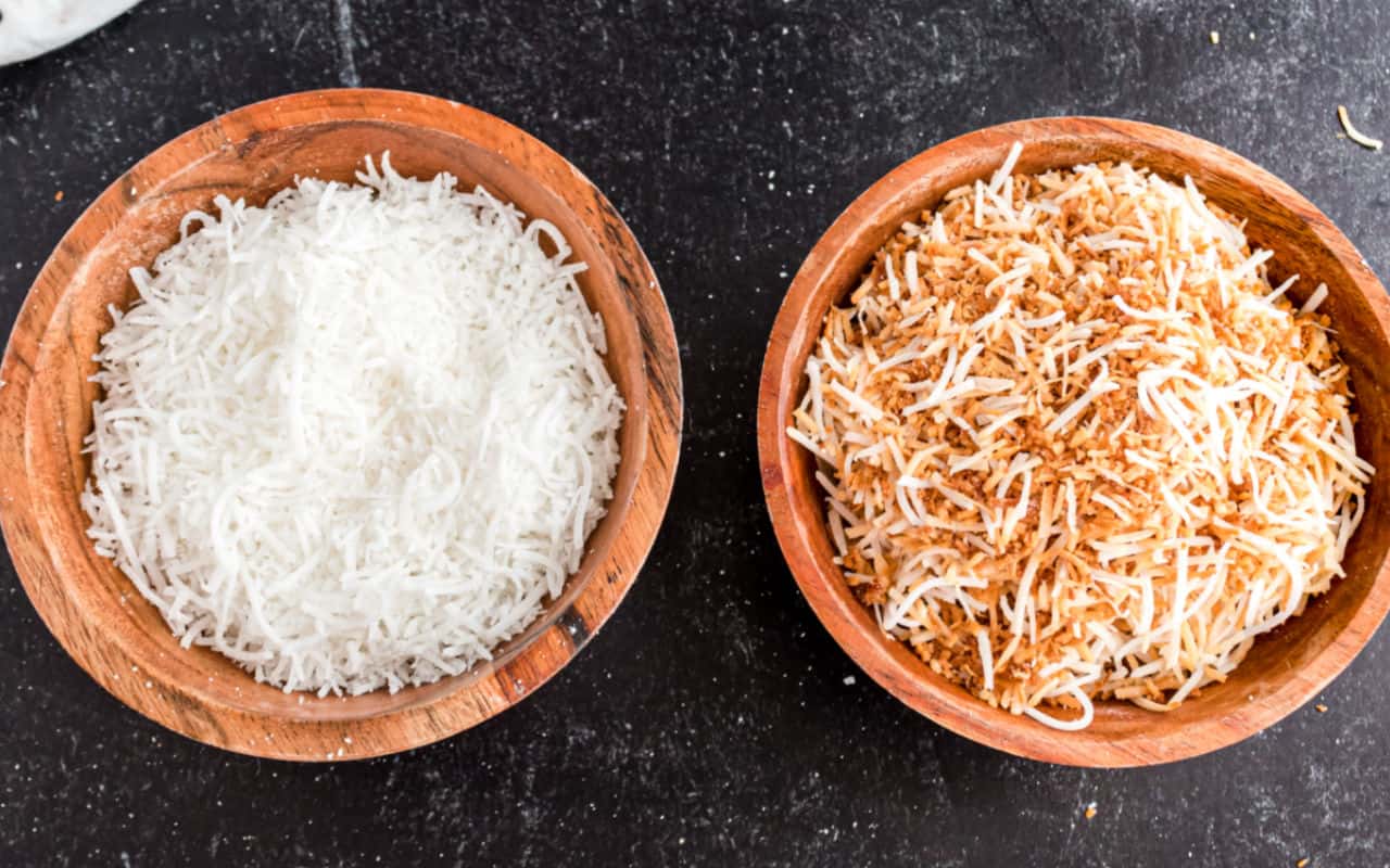 Two bowls of coconut, one is toasted.