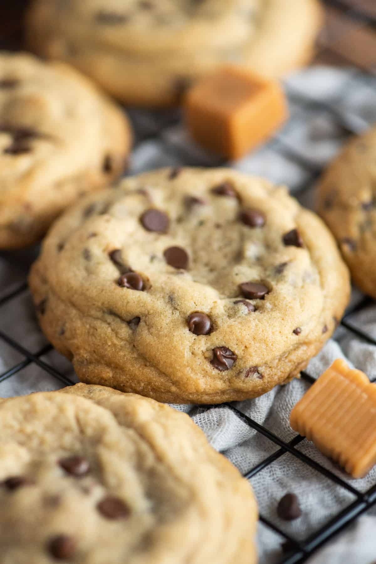 Caramel stuffed chocolate chip cookies on wire rack to cool.