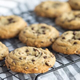 Caramel stuffed chocolate chip cookies on cooling rack.