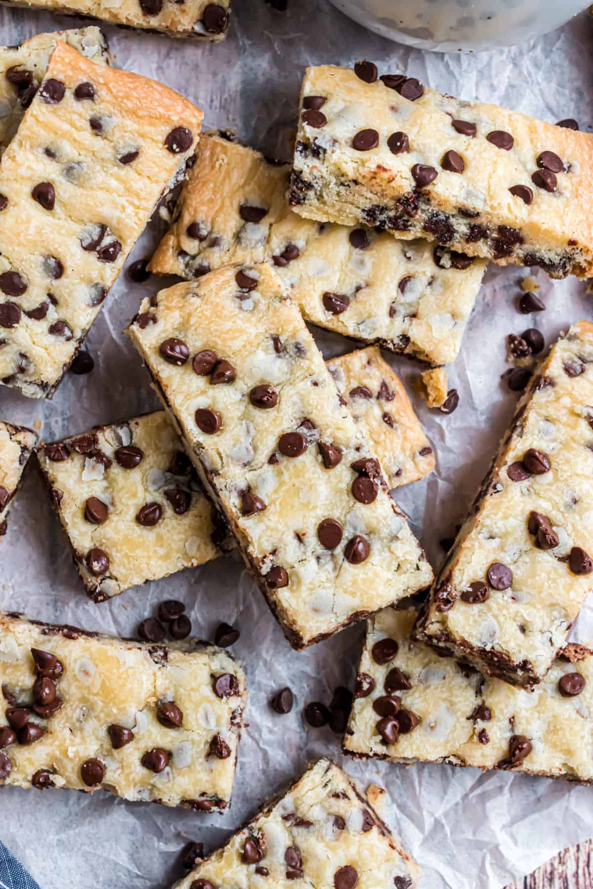 Shortbread cookie bars on parchment paper cut into rectangles.