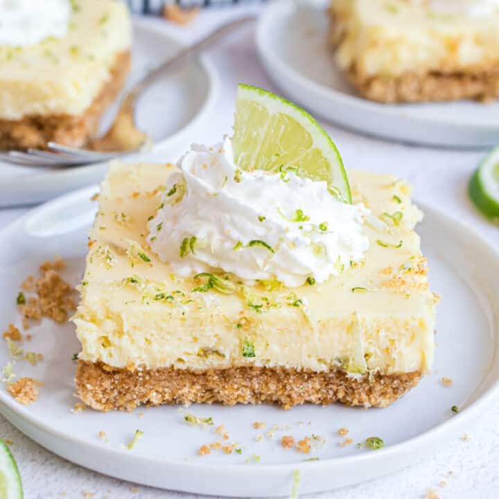 Slice of key lime pie bar on a white plate.