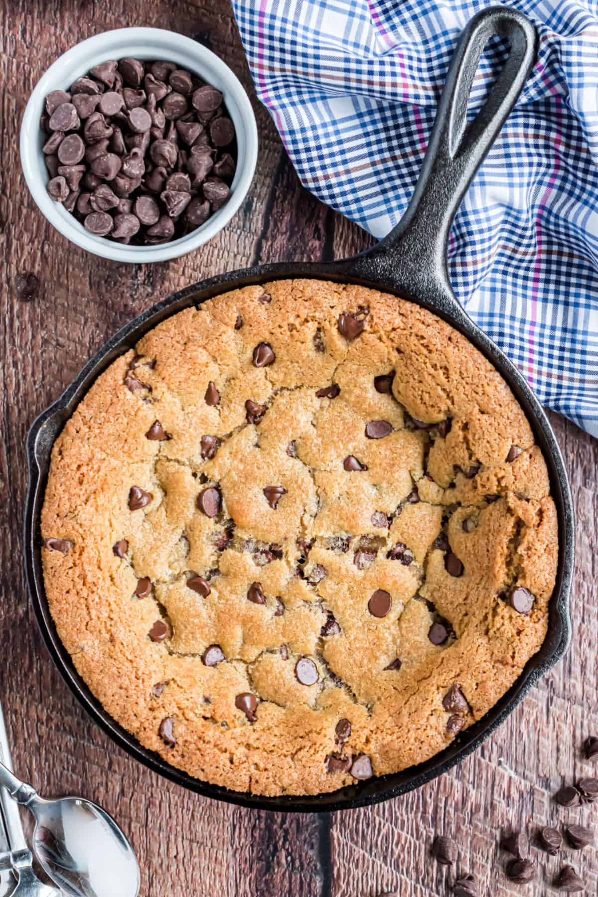 Chocolate chip cookie in a cast iron skillet.