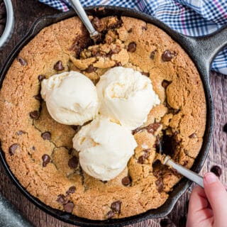 Chocolate chip cookie baked in a cast iron skillet and topped with vanilla ice cream.