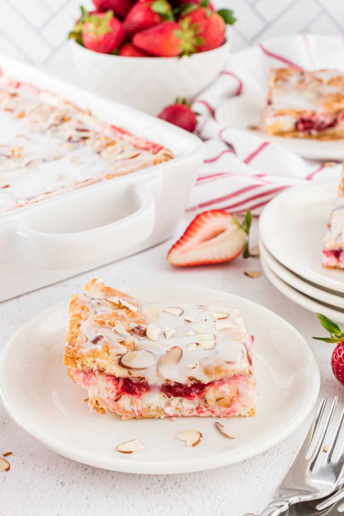 Strawberry danish slice on a white plate.