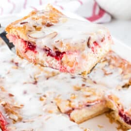 Strawberry cheesecake danish lifted out of the baking dish.