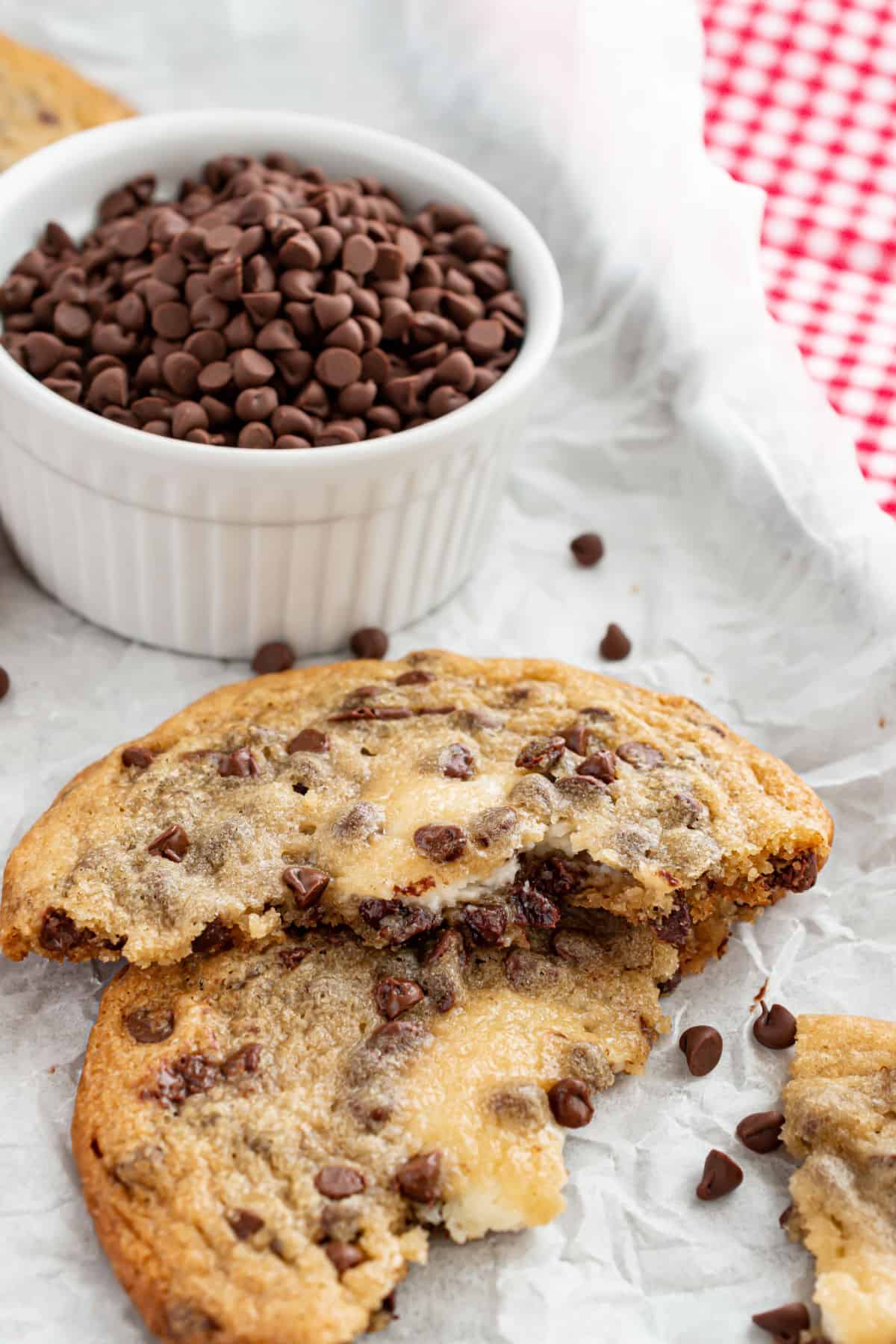 Chocolate chip cheesecake cookie broken in half.