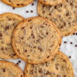 Giant chocolate chip cookies stacked on top of eachother.