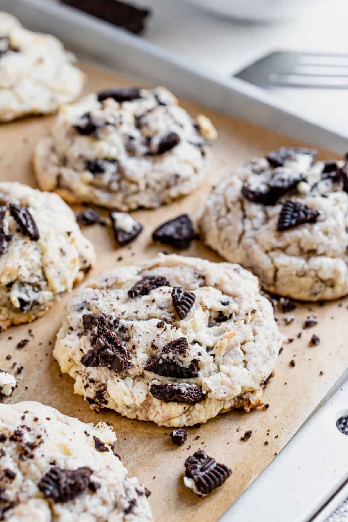 Oreo cookies on a parchment paper lined baking sheet.