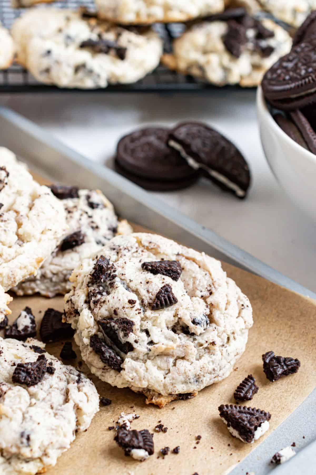 Oreo cookies stacked on parchment paper lined cookie sheet.