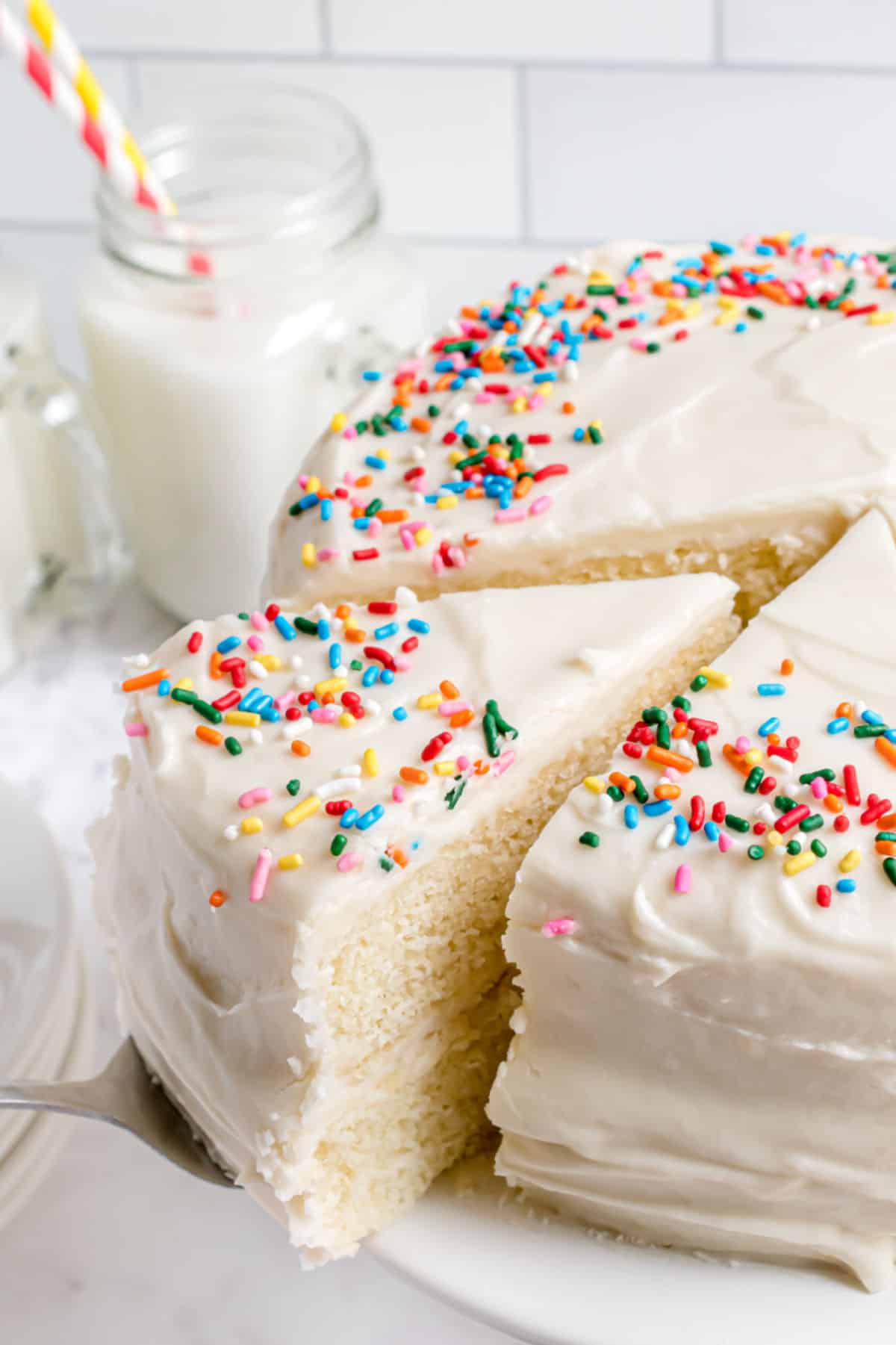 Vanilla layer cake with vanilla frosting and sprinkles.