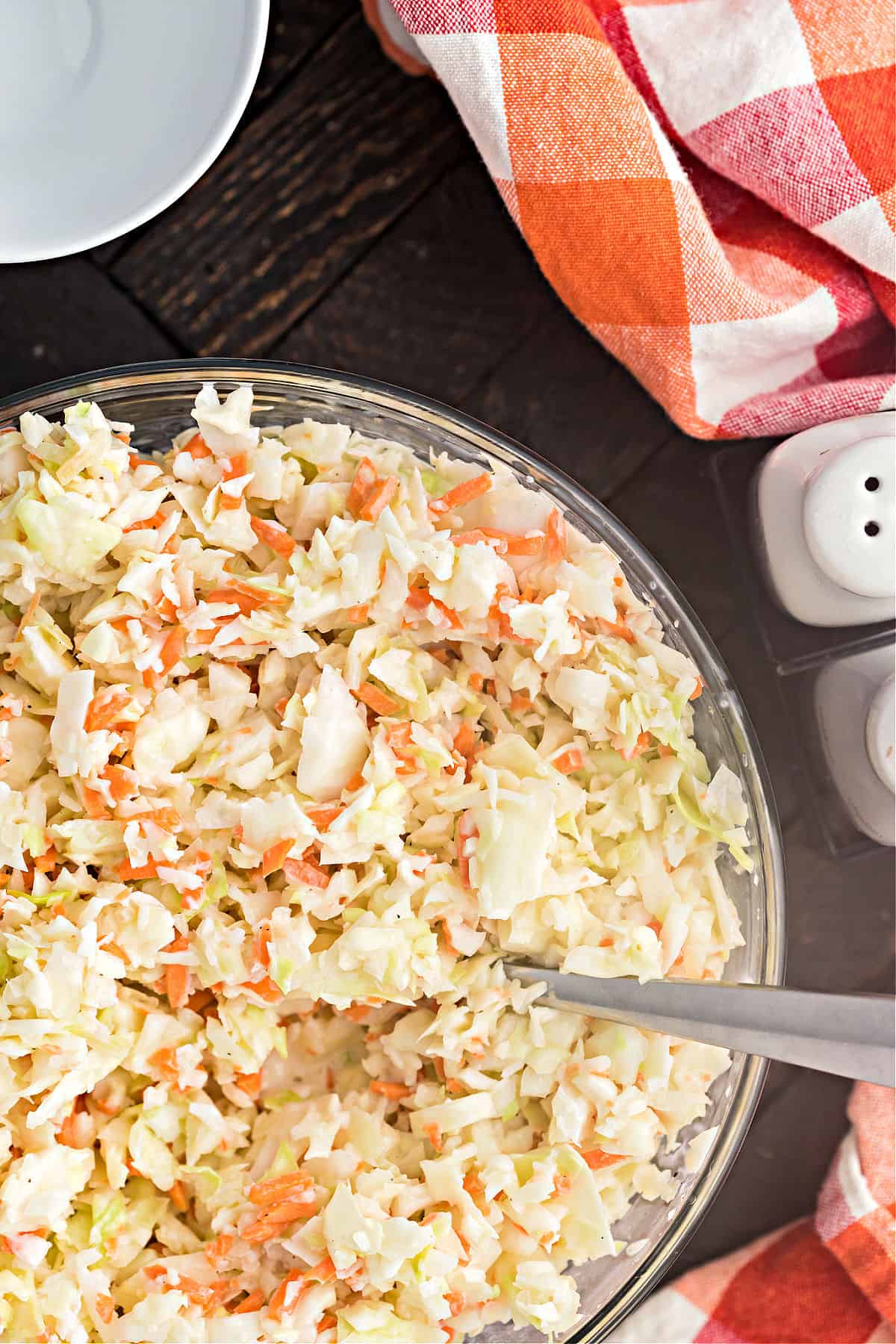 Coleslaw in a serving bowl with spoon.