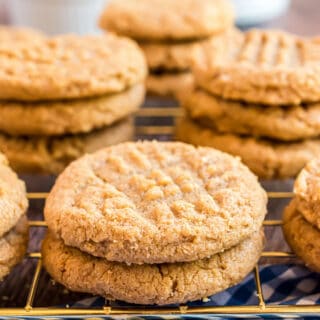 Stacks of peanut butter cookies on wire cooling rack.