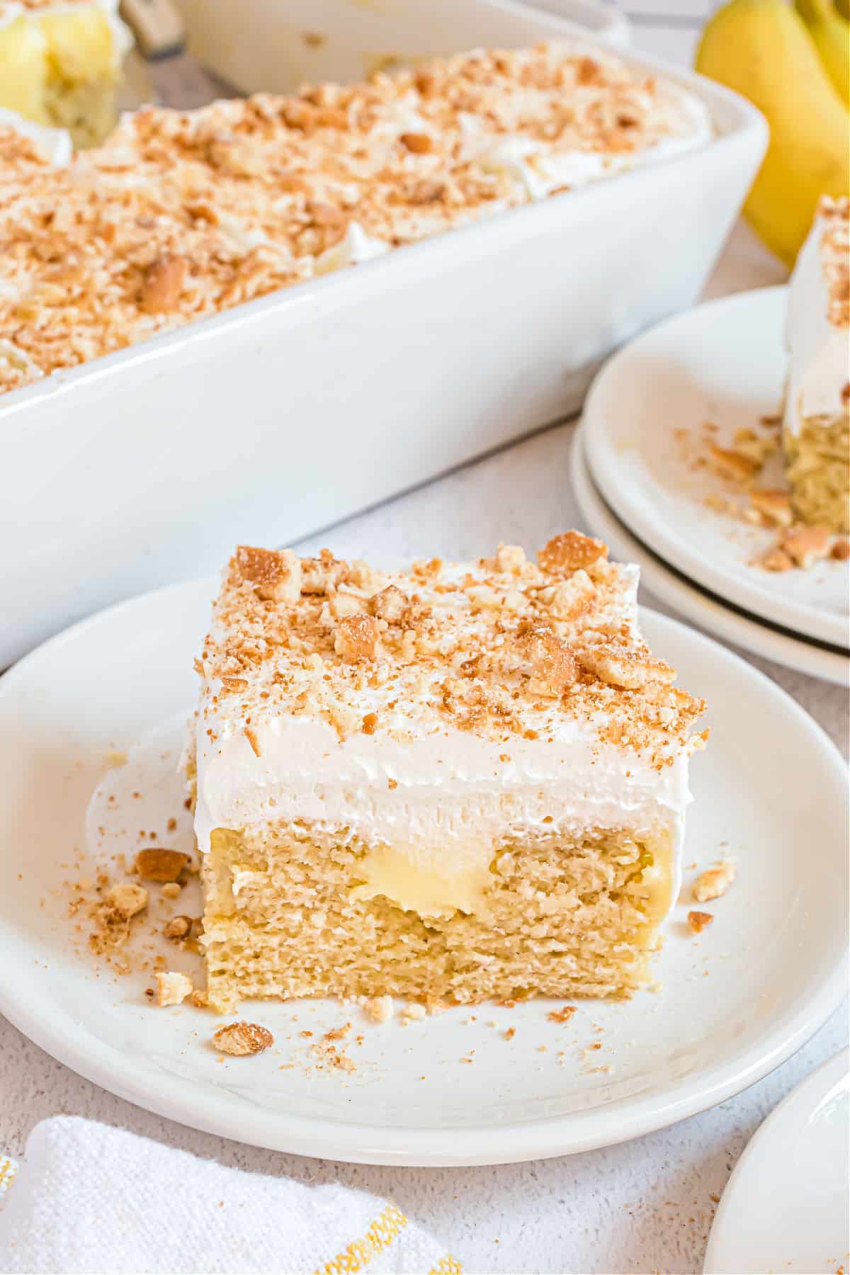 Slice of banana pudding cake on a white plate.