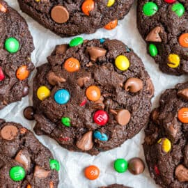 Chocolate M&M cookies on parchment paper.