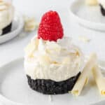 White chocolate no bake cheesecake with oreo crust and fresh raspberry.