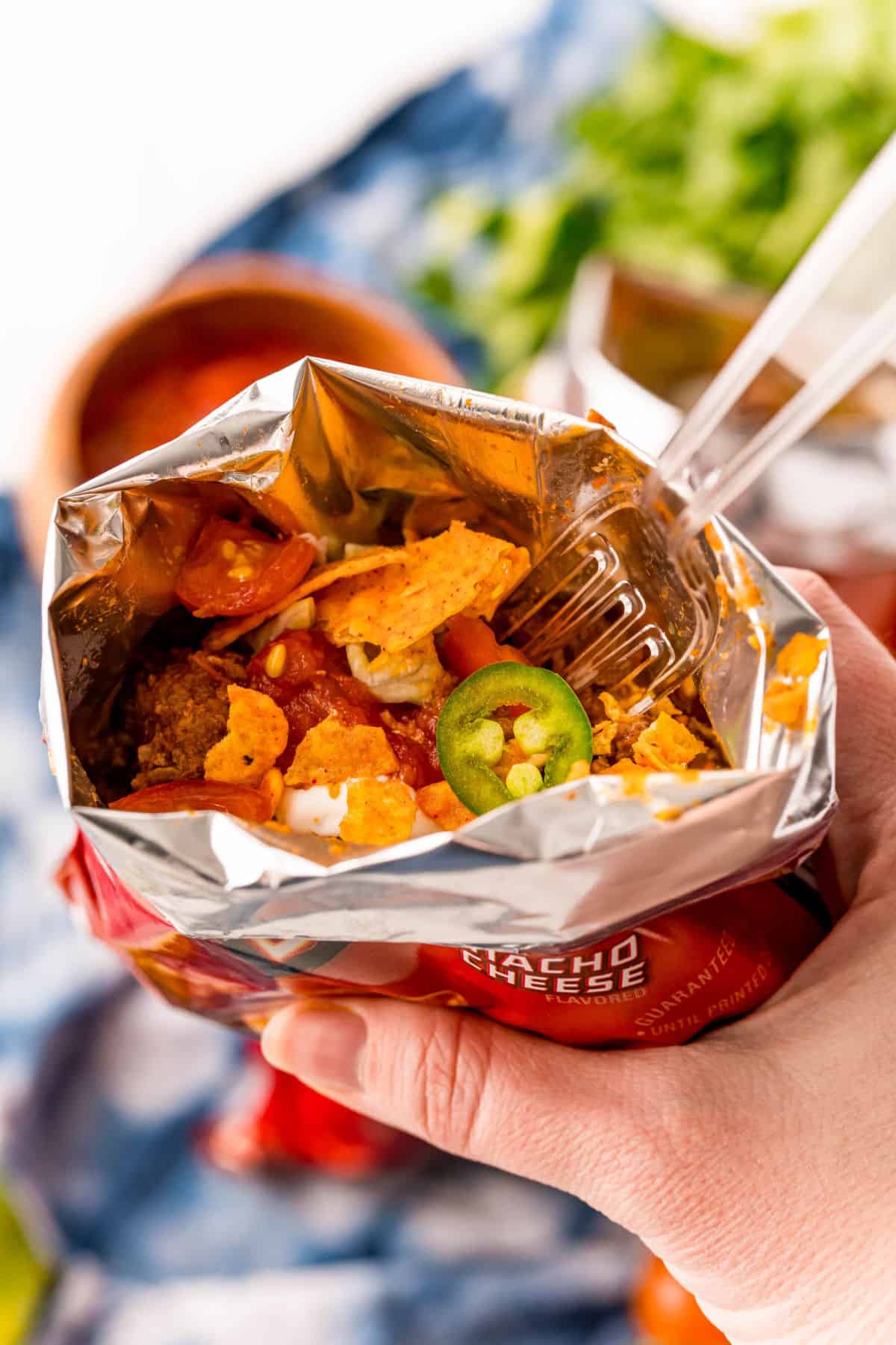 Dorito bag filled with chips, taco meat, and toppings. 