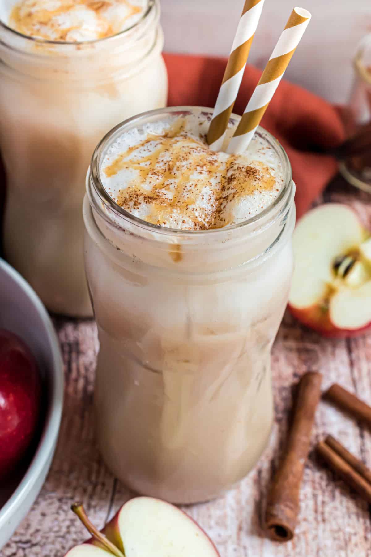 Apple crisp macchiato served over ice with a straw.