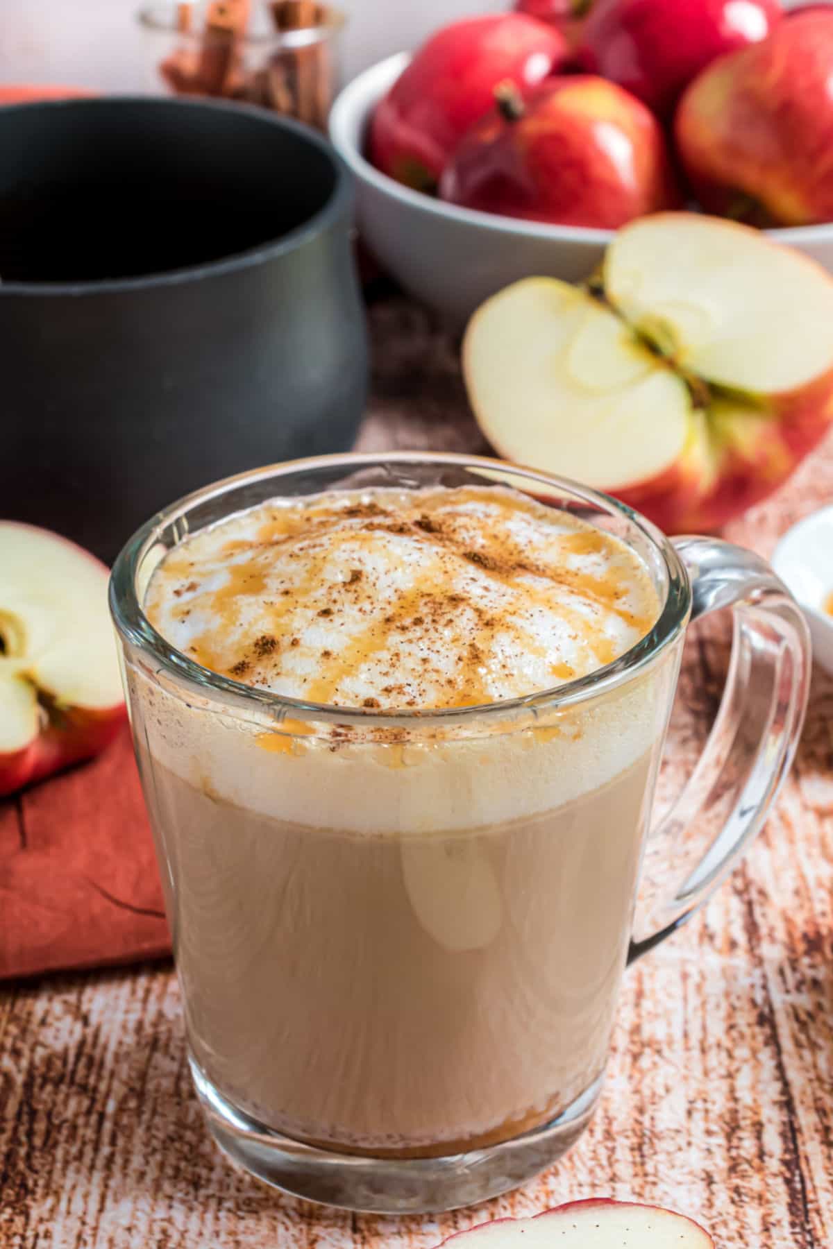 Copycat starbucks apple crisp macchiato in a clear glass mug.