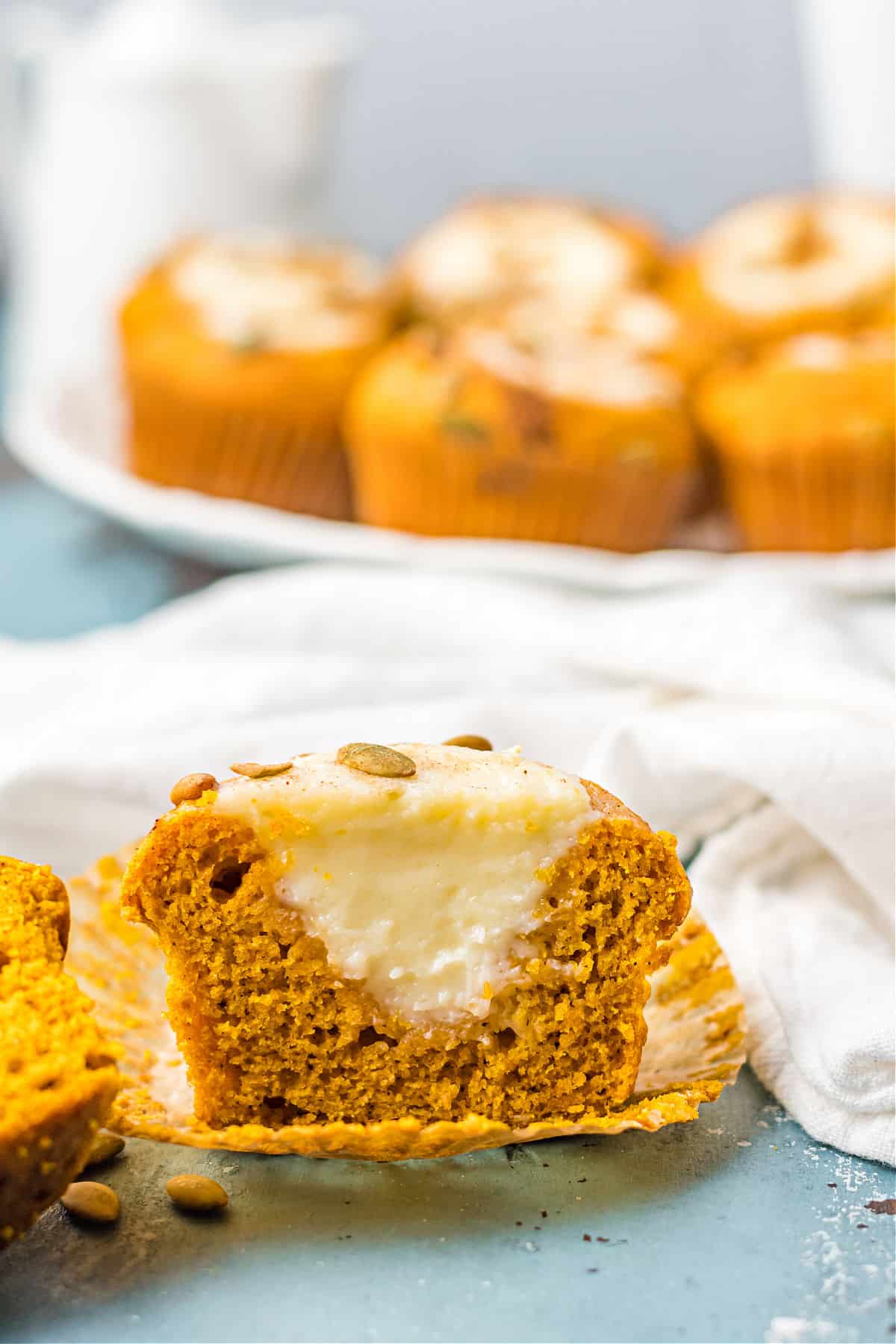 Pumpkin muffin with cream cheese filling cut in half.