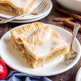 Slice of apple slab pie on a white dessert plate.