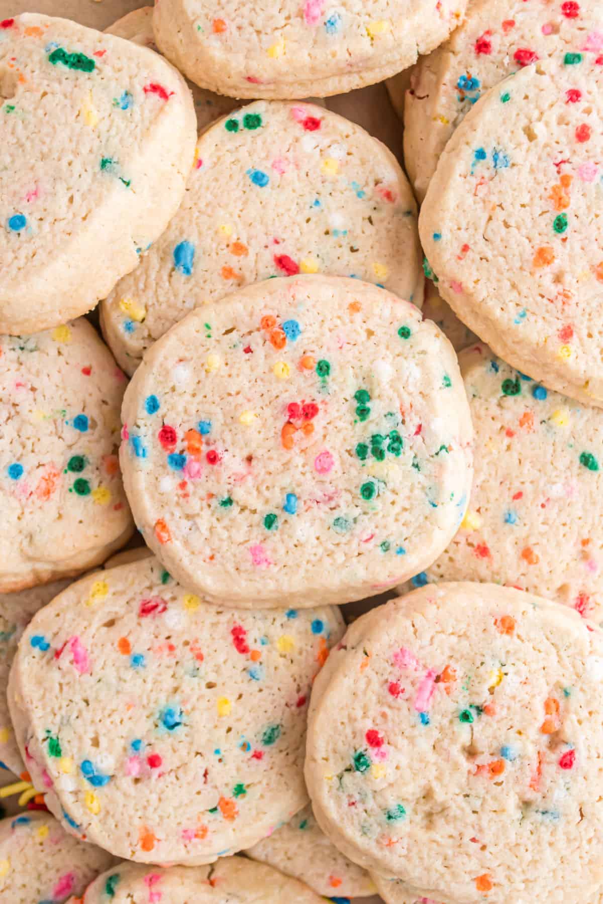 Icebox cookies with sprinkles stacked on top of eachother.