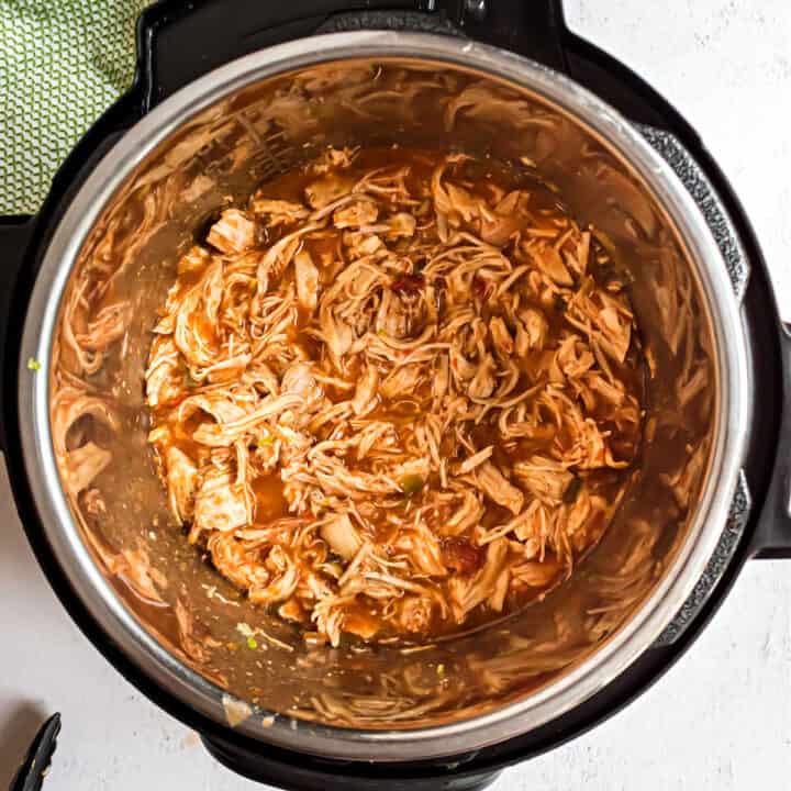 Shredded salsa chicken in Instant Pot for tacos.