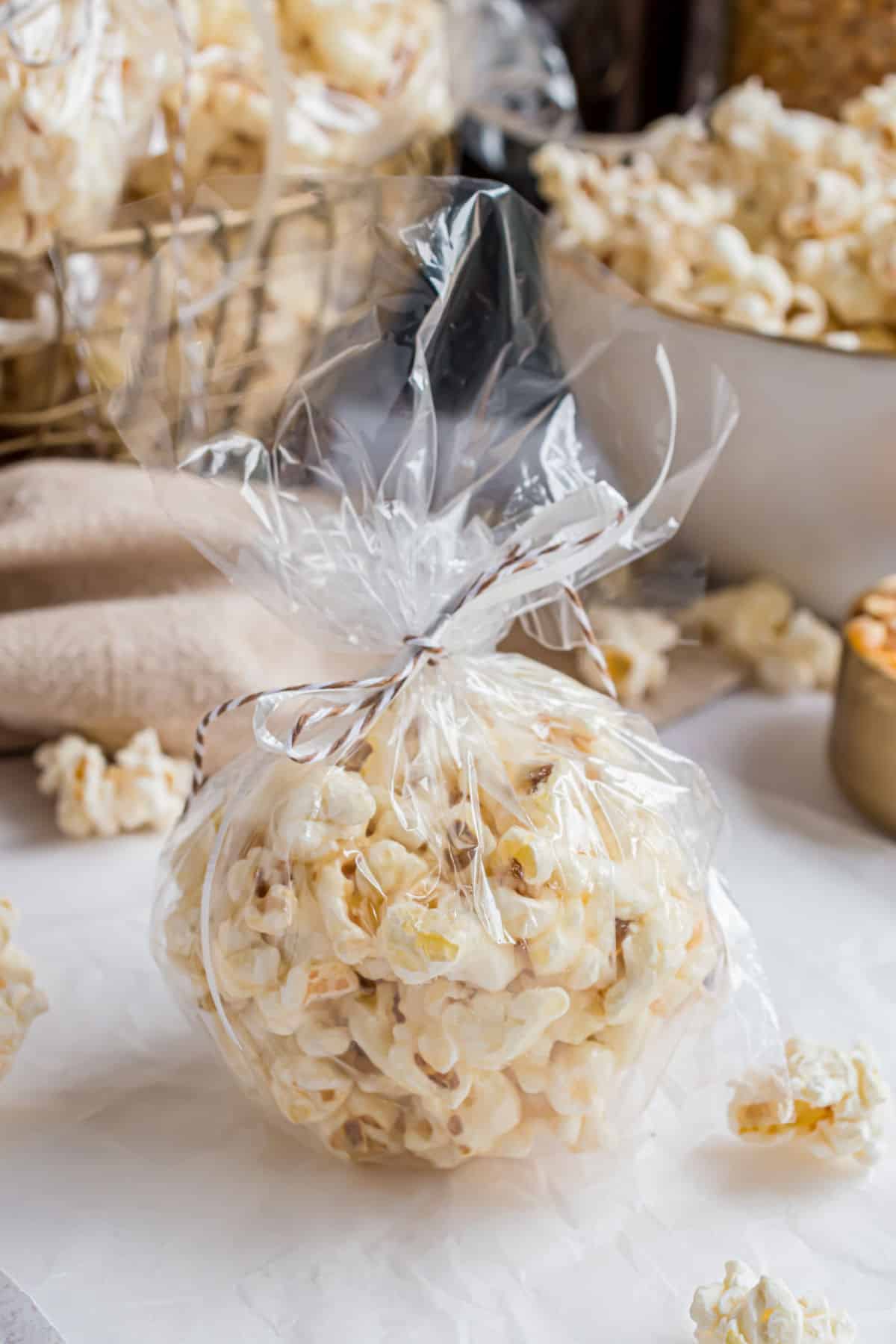 Homemade popcorn balls wrapped in baggies and tied off with string for gifts.