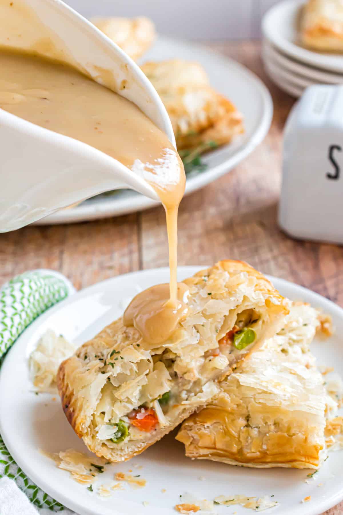 Turkey gravy poured over homemade turkey pot pies.