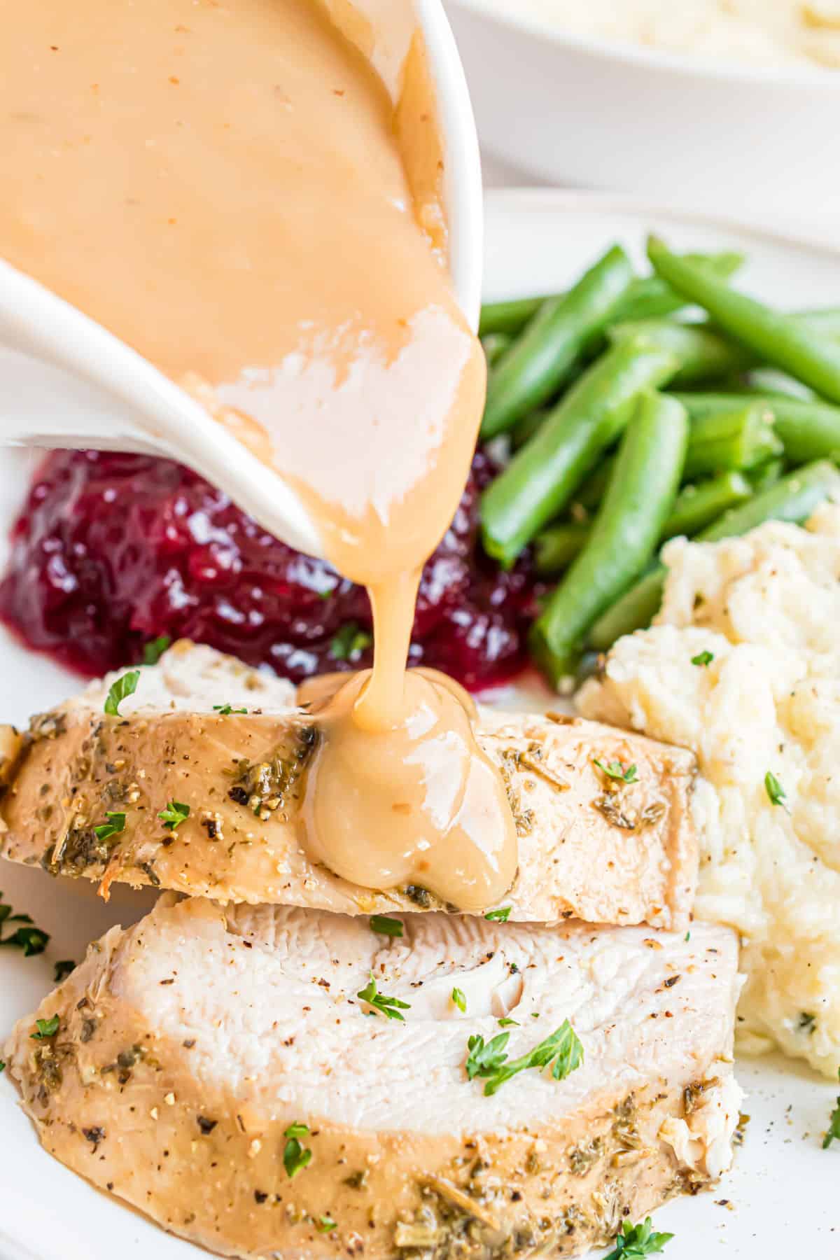 Turkey gravy poured over slices of turkey breast.