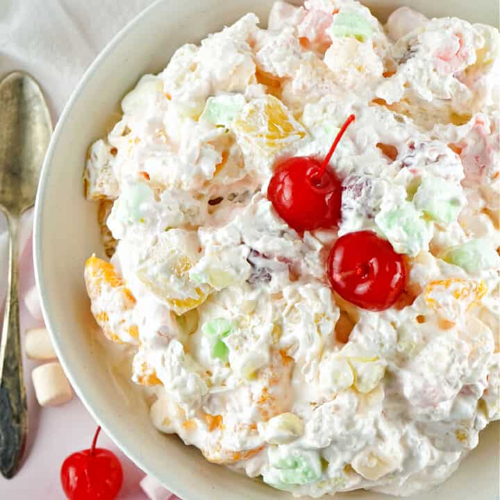 Bring extra sweetness to your holiday table with this Ambrosia Salad recipe! Canned fruit gets tossed with whipped cream and marshmallows for an easy and irresistible side dish.