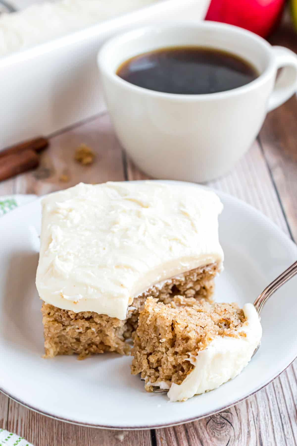 Slice of applesauce cake with a fork taking a bite.