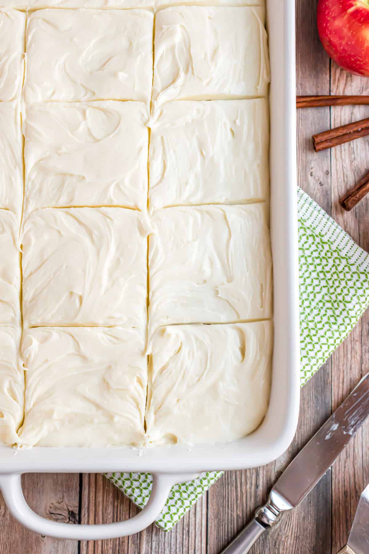 Applesauce cake with cream cheese frosting in a white 13x9 baking pan.