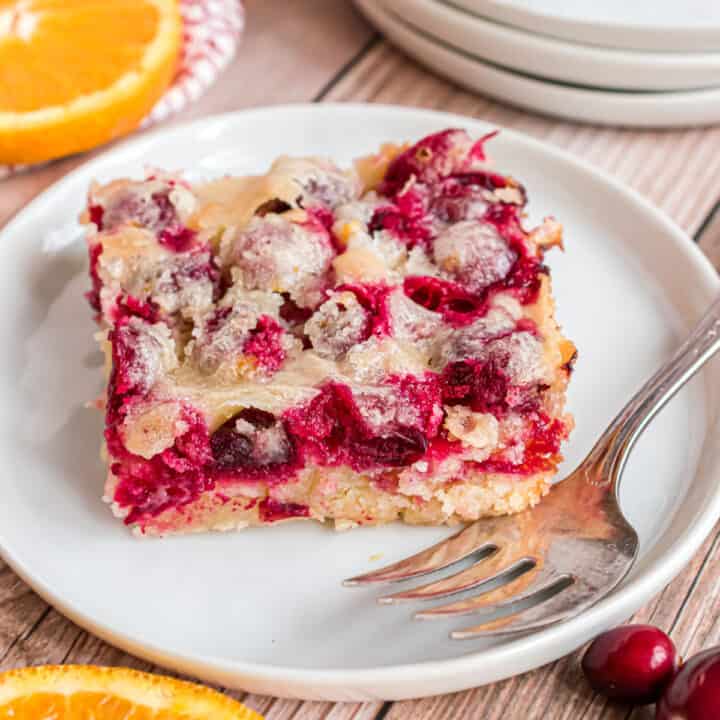 Ready to impress your Christmas guests? Cranberry Christmas Cake is easy to make with an incredible combination of sweet and tart flavors. Tender moist cake with hints of vanilla and almond and bursting with fresh cranberries.