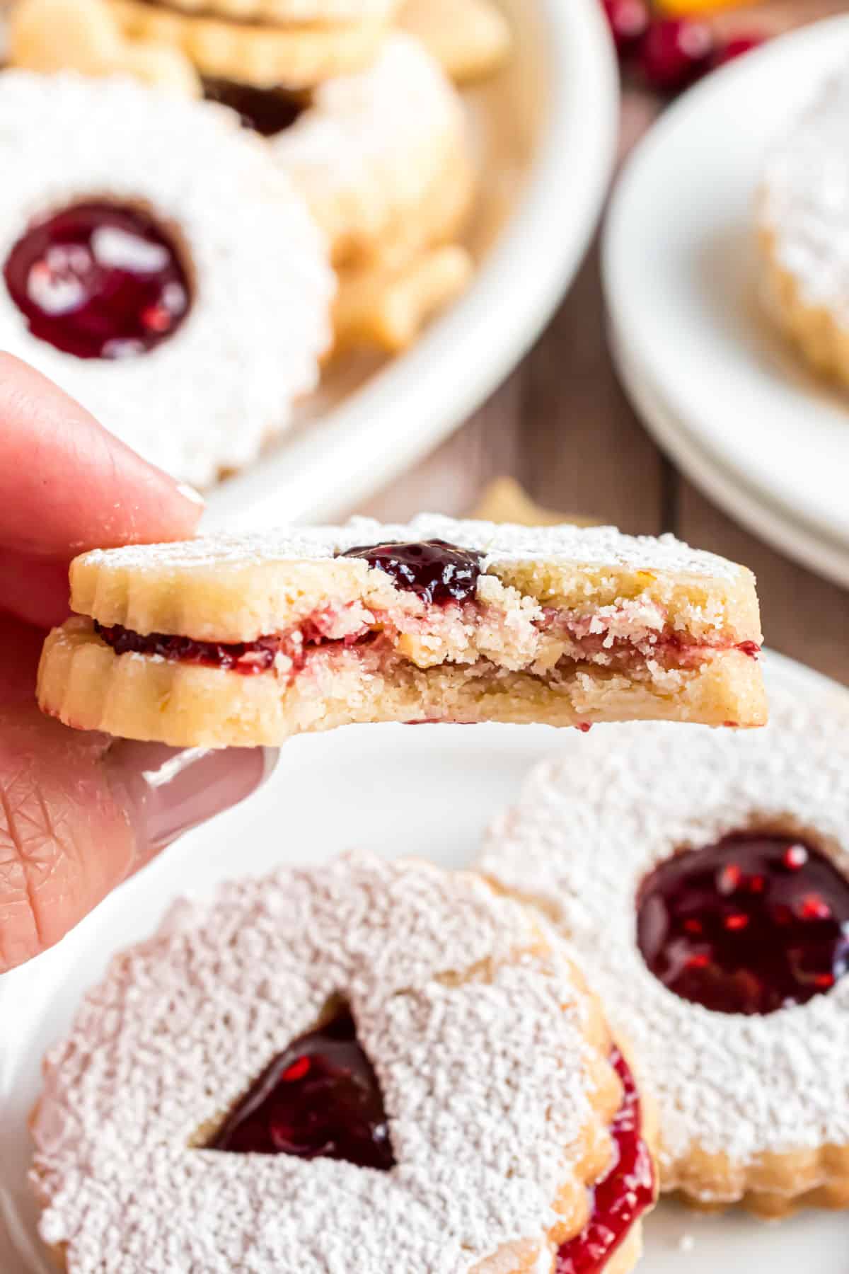 Linzer cookies with a bite taken.