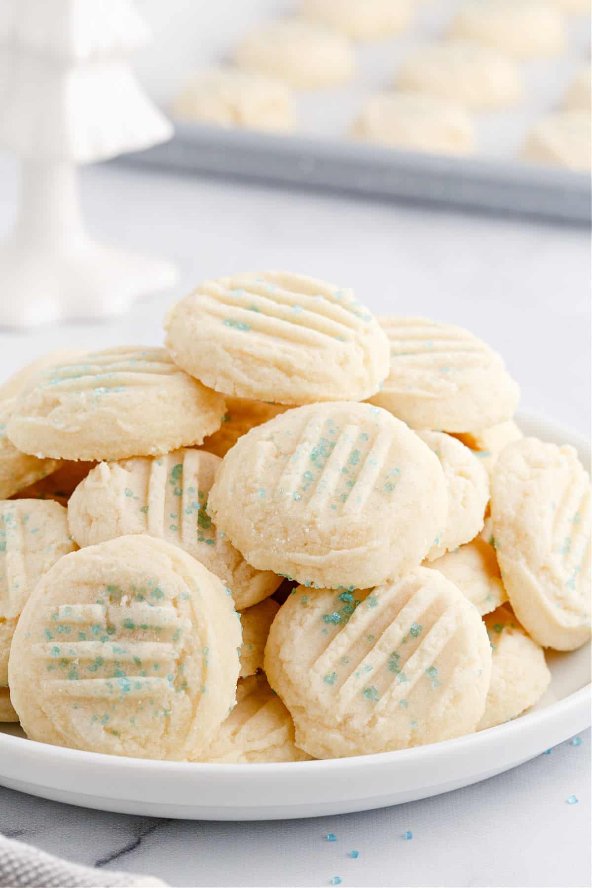 Plate stacked with whipped shortbread cookies.