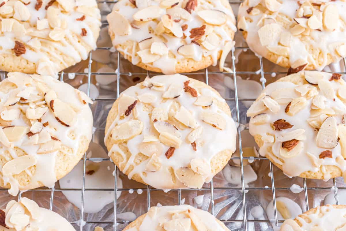 Almond glazed cookies on a wire cooling rack.