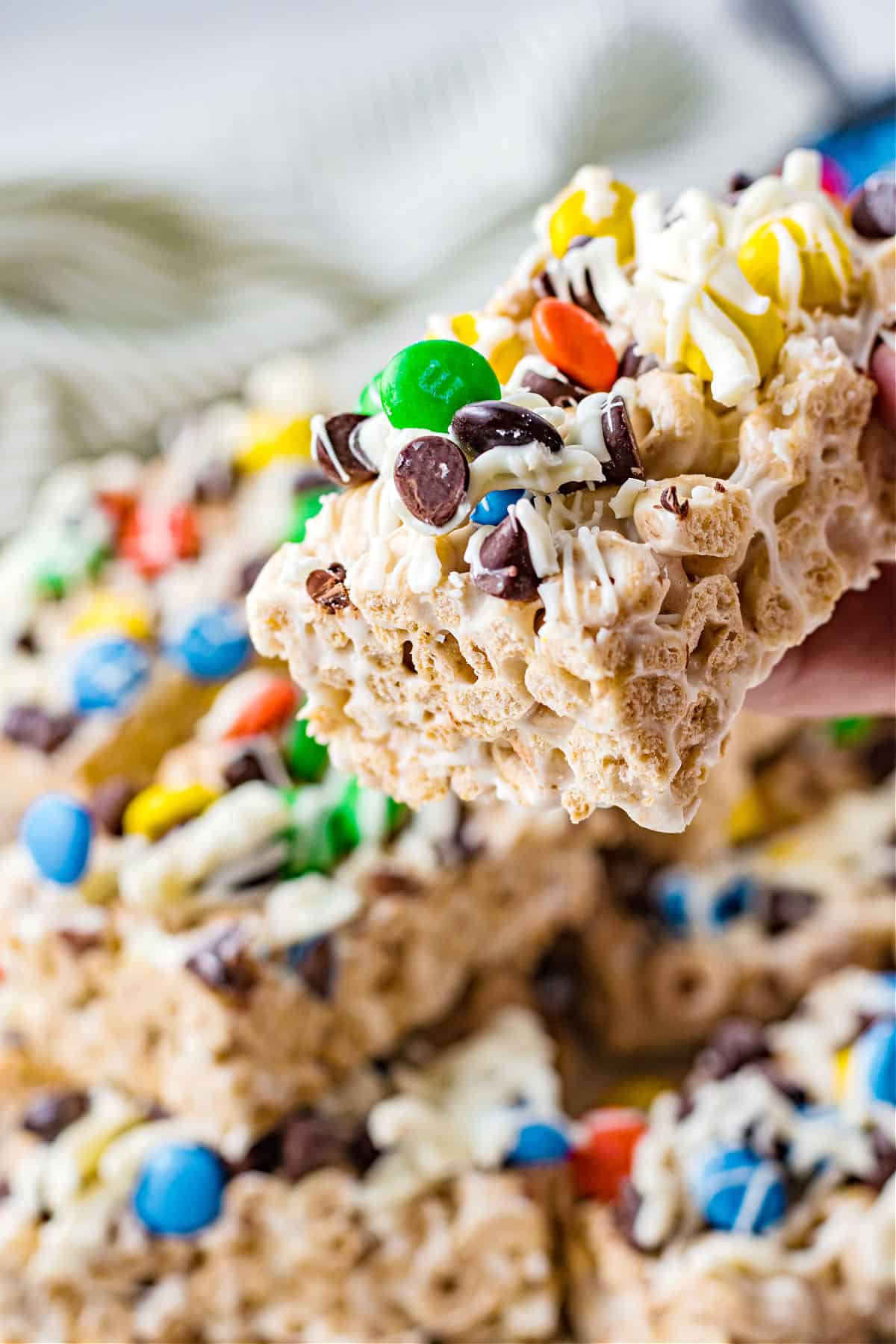 Cheerio cereal bars topped with white chocolate and M&Ms.