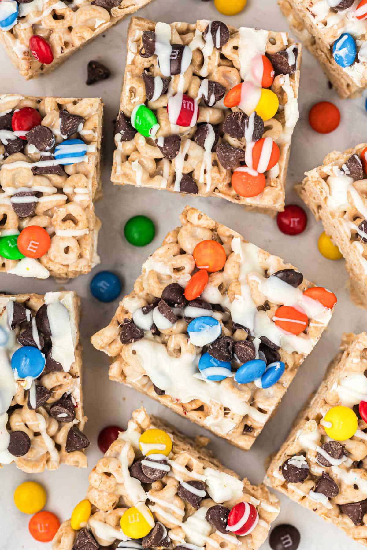 Big squares of cheerio bars with colorful candies on top.