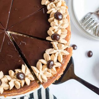 The great taste of Cheesecake and Bailey's Irish Cream all in one dessert! This Baileys Cheesecake recipe has an oreo cookie crust, creamy cheesecake with Irish Cream, chocolate ganache, and an espresso whipped cream!