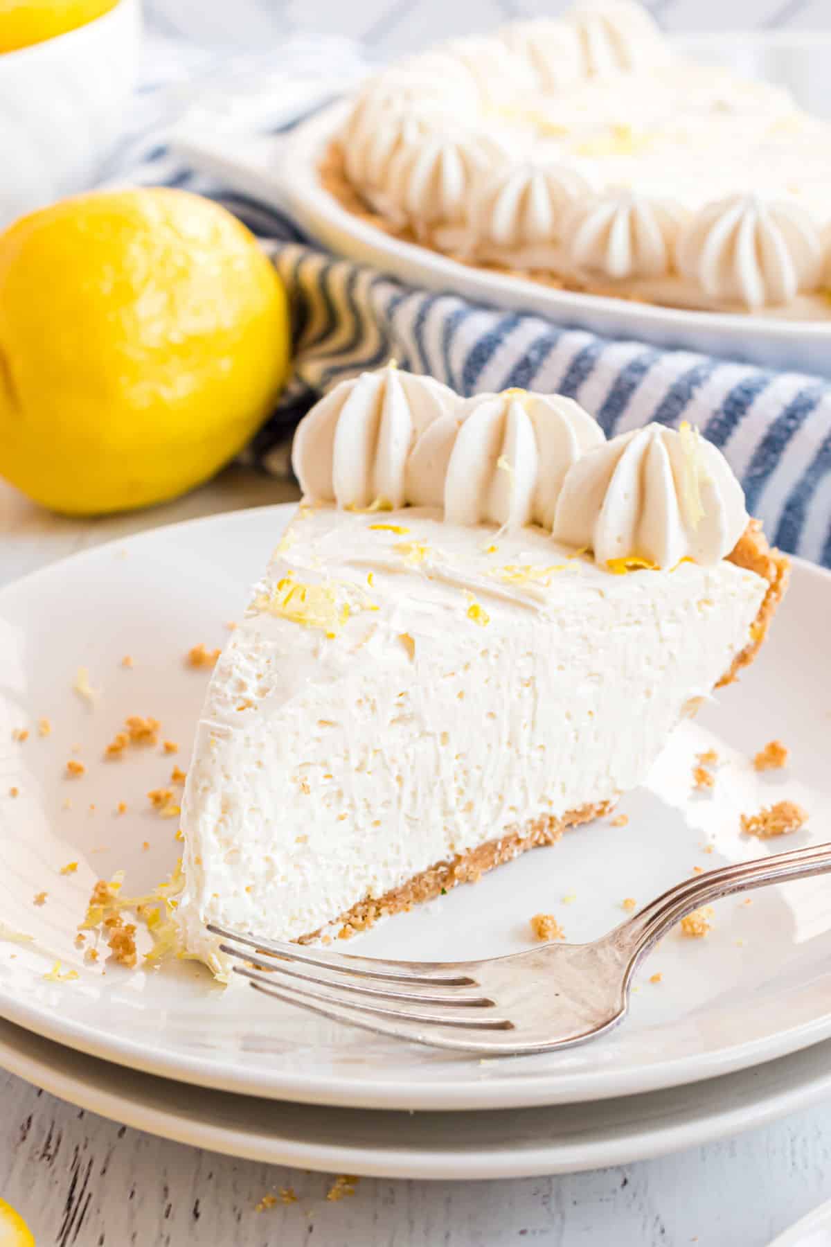 Slice of lemon cheesecake sprinkled with lemon zest.