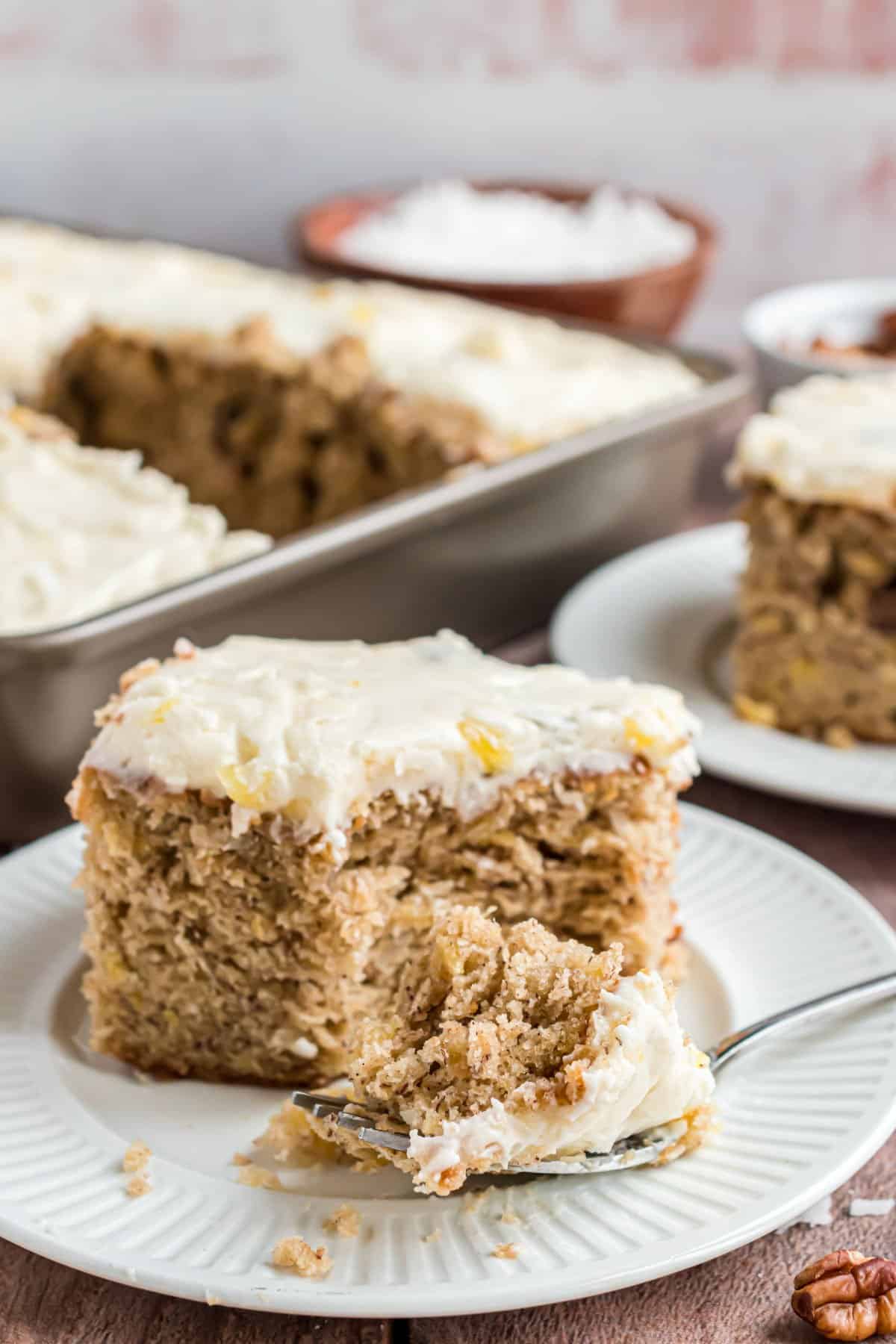 Hummingbird sheet cake made in a 13x9 and served on a white plate.